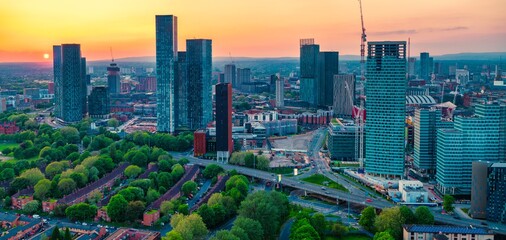 Fototapeta premium Aerial panorama of the sun setting down over the Horizon of Manchester