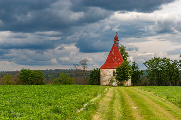 Old church in the summer field. Dobronice u Bechyne, Czech republic.