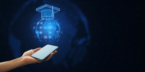 Close up of female hand holding smartphone with creative glowing online education hologram on dark blue polygonal background with mock up place. E-learning and course concept.