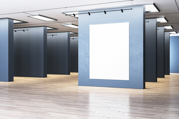Blank white poster in a frame on a gallery wall with spotlights, on a wooden floor and plain...