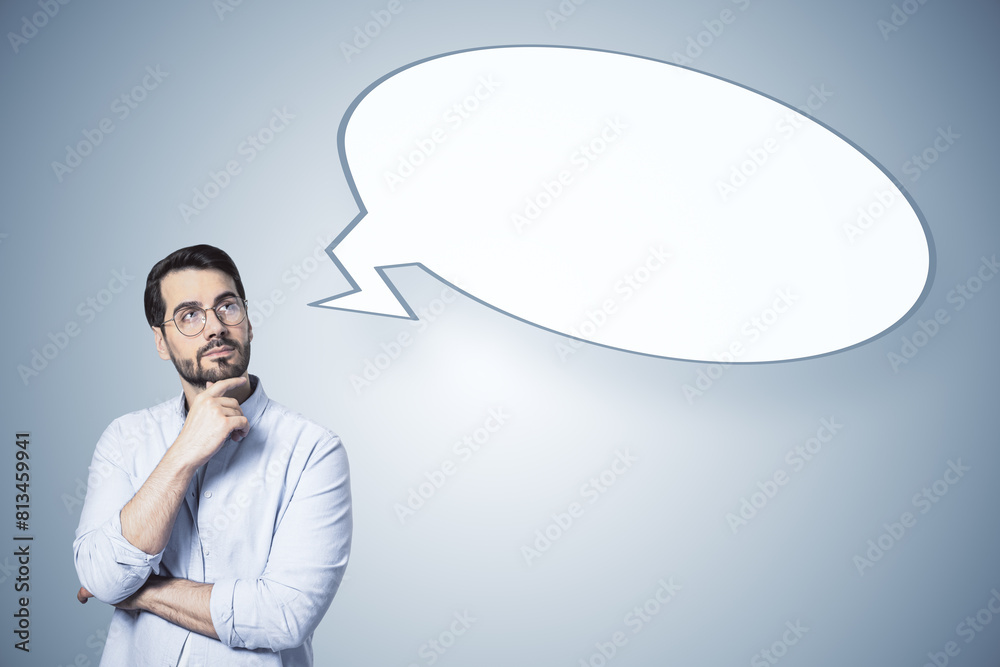 Poster A man in a thoughtful pose with an empty speech bubble, on a plain background, illustrating the concept of thinking
