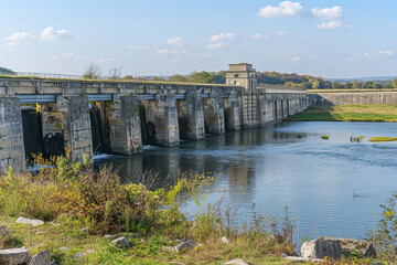 Fototapeta premium Generative ai on theme of hydroelectric power energy plant with large turbines and water spills