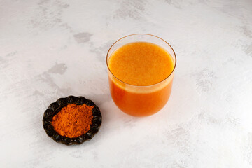 Buckthorn and mango fruits energy drink with natural turmeric powder on the table, top view....