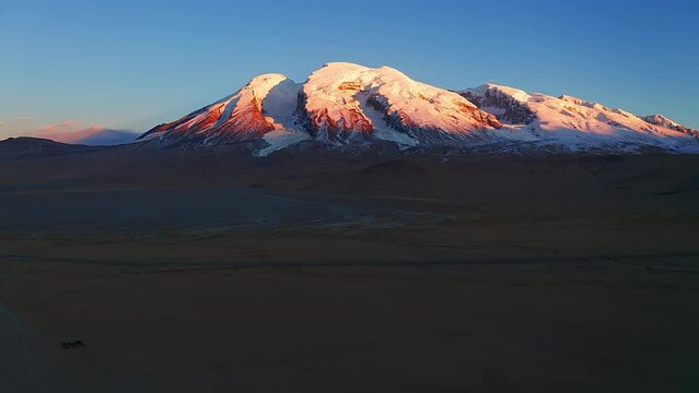 Aerial view of the snow-capped Mount Muztagh Ata in the Pamir Plateau of Xinjiang, China, during the sunset of the colorful sunset.