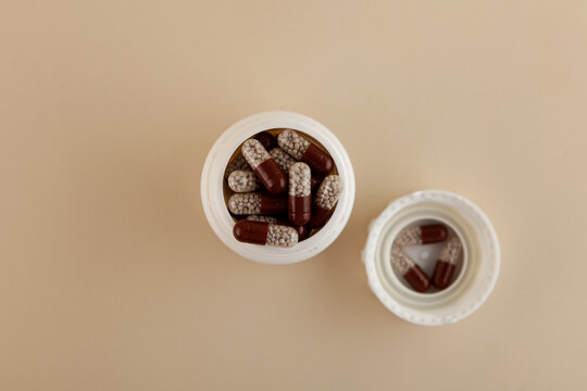 Opened packaging with Creon capsules, top view. Selective focus. Capsules filled with gastro-resistant granules. Pancreatic enzymes, also known as pancreases or pancrelipase and pancreatin