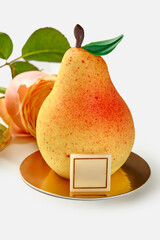 Artisan dessert in shape of pear on gold plate