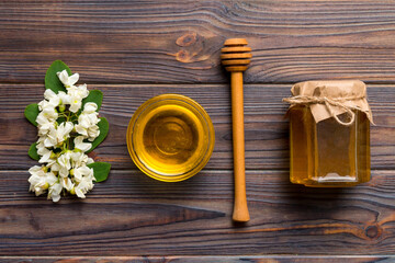 honey jar with acacia flowers and leaves. fresh honey top view flat lay