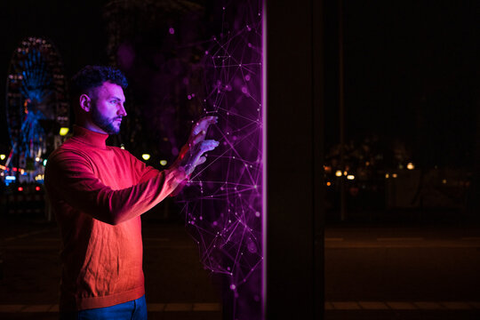 Businessman examining big blockchain data at night