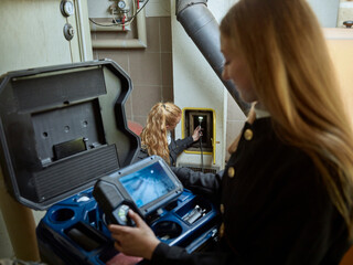 Chimney sweepers controlling exhaust gases in boiler room