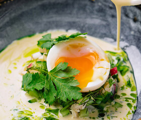Gourmet poached egg breakfast bowl with hollandaise sauce