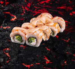Exotic sushi rolls on textured lava plate