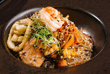 Exquisite gourmet seafood pasta on elegant dark plate