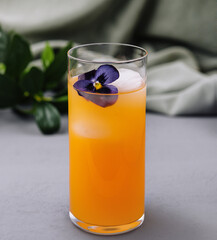 Elegant cocktail with edible flower garnish