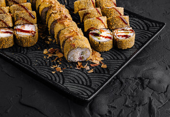 Delectable assorted sushi rolls on elegant black plate