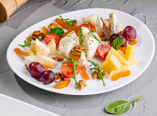 Assorted fruit and cheese plate.Close-up of delicious food plate
