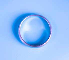 Ring on pastel blue background. Round cyan frame.