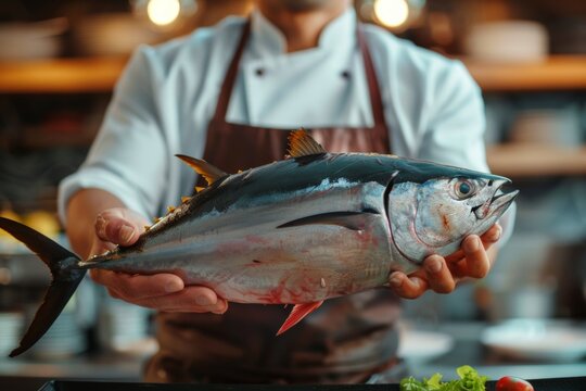 Expert chef proudly presenting a freshly caught tuna, exemplifying a commitment to excellence in seafood cuisine.