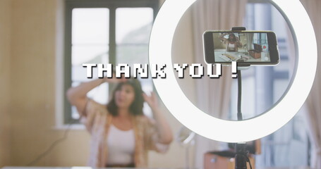 Image of thank you text over caucasian woman making vlog using smartphone