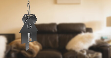 Image of key with keychain in shape of house over living room interior