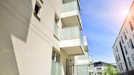 Contemporary residential building exterior in the daylight. Modern apartment buildings on a sunny day with a blue sky. Facade of a modern apartment building