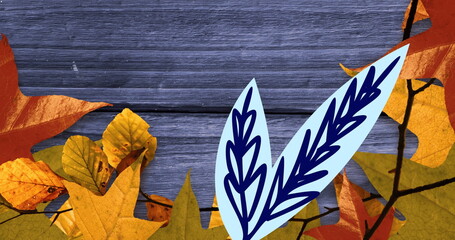 Image of leaves and leaf drawing on wooden background