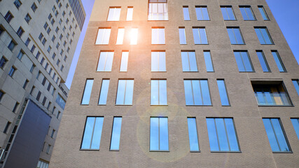 Modern office building detail. Perspective view of geometric angular concrete windows on the facade of a modernist brutalist style building. 