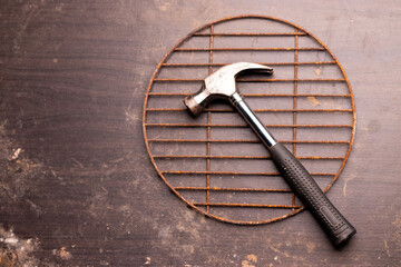 Metal hammer kept on a wooden background