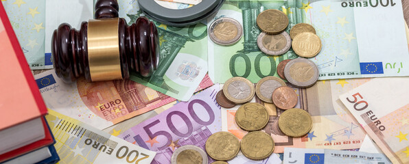auction hammer on eu euro money banknotes as finance background