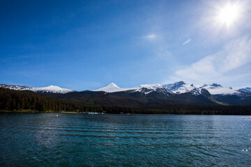 Summer landscape and people kayaking and fishing in Maligne lake, Jasper National Park, Canada