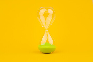 Hourglass on yellow background, time and countdown time limit for urgent work to meet deadlines and...