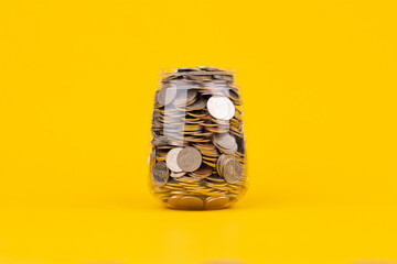 Saving money in a glass jar creates financial discipline, good accounting and planning for...