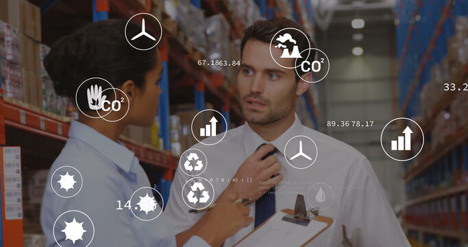 Image of eco icons and data processing over diverse man and woman working in warehouse
