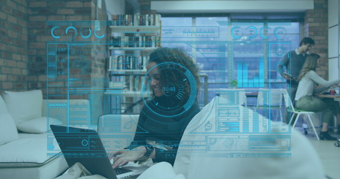 Image of interface with data processing over african american woman using laptop at office