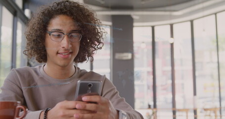 Image of financial data processing over biracial man using smartphone in office