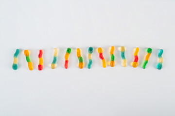 Fruit flavored worm shape, jelly candies. Isolated on white background.