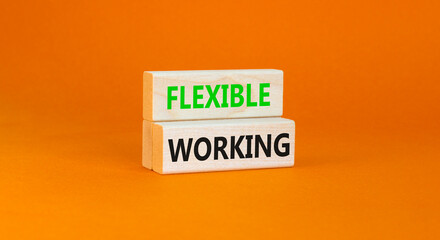 Flexible working symbol. Concept words Flexible working on beautiful wooden block. Beautiful orange paper background. Business flexible working concept. Copy space.