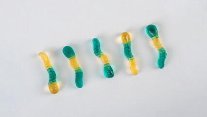 Fruit flavored worm shape, jelly candies. Isolated on white background.