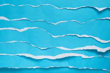 Torn blue paper strips simulating sea waves. Background, texture.