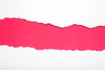 Torn white paper on dark pink background. Space for text.