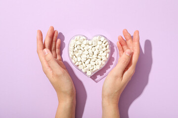 Hormonal pills for the heart, on a purple background.