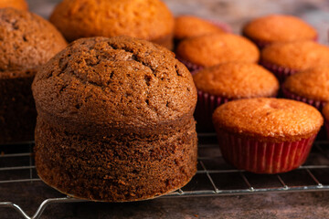 Small freshly baked cake and cupcakes. Pastry table.