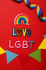LGBT parade concept, colorful symbols on red background.