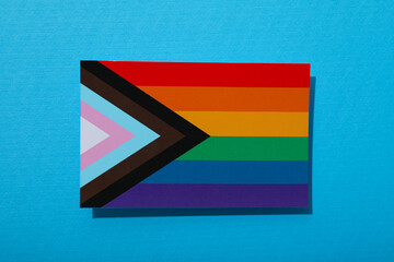 LGBT parade concept, festive colorful symbols on blue background.