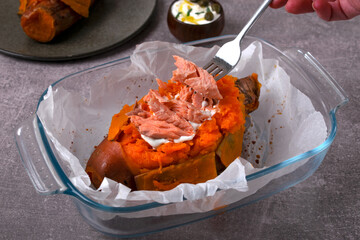 Cooking baked stuffed sweet potato with hot smoked trout and sour cream sauce. Adding the fish on...