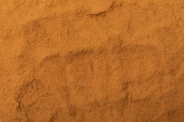 Cinnamon powder  isolated on white background. Spicy spice for baking, desserts and drinks. Fragrant ground cinnamon.