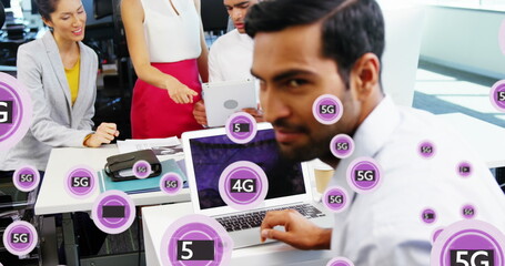 Image of 4g, 5g text and symbols in circles over diverse coworkers discussing reports in office