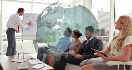 Image of spinning globe against caucasian businessman giving a presentation at office - Powered by Adobe