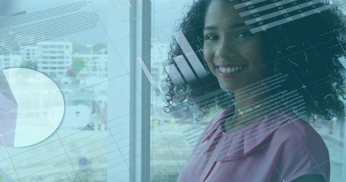 Image of data processing over african american businesswoman using laptop