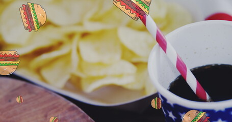 Potato chips resting in bowl, a soda with a striped straw nearby