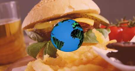 Image of globe icon over fast food with hamburger, chips and onion rings